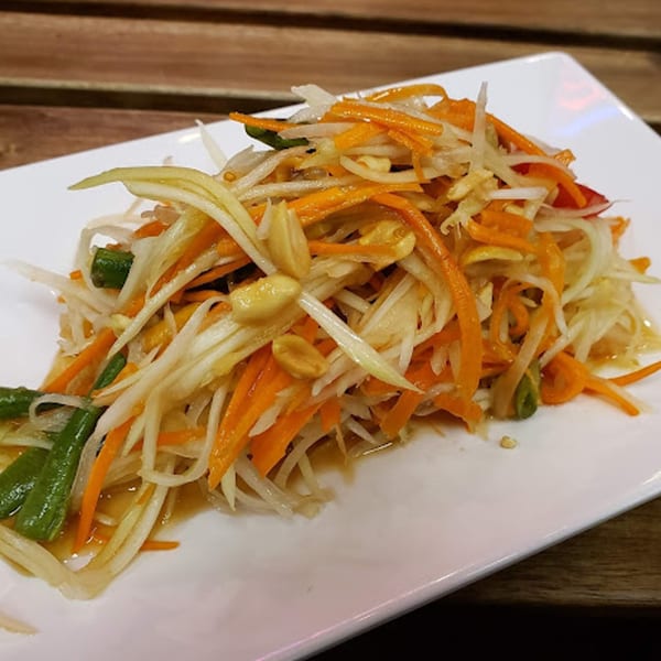 Close-up of Kao Sarn Thai Street Food's papaya salad with shredded carrots, green beans, and peanuts.