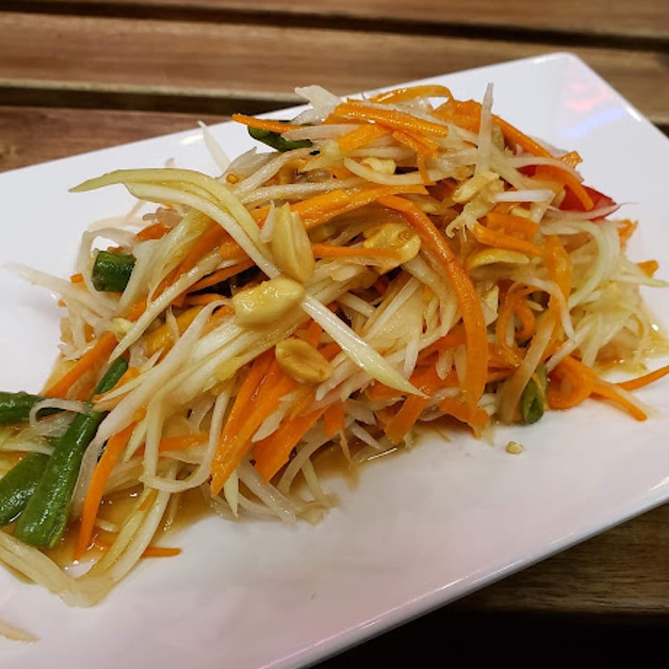 Close-up of Kao Sarn Thai Street Food's papaya salad with shredded carrots, green beans, and peanuts.
